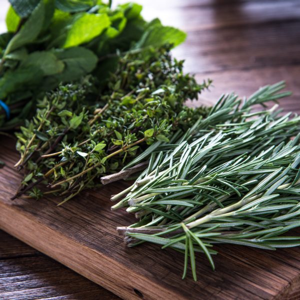 herbal supplements for dogs - fresh herbs on a wooden board